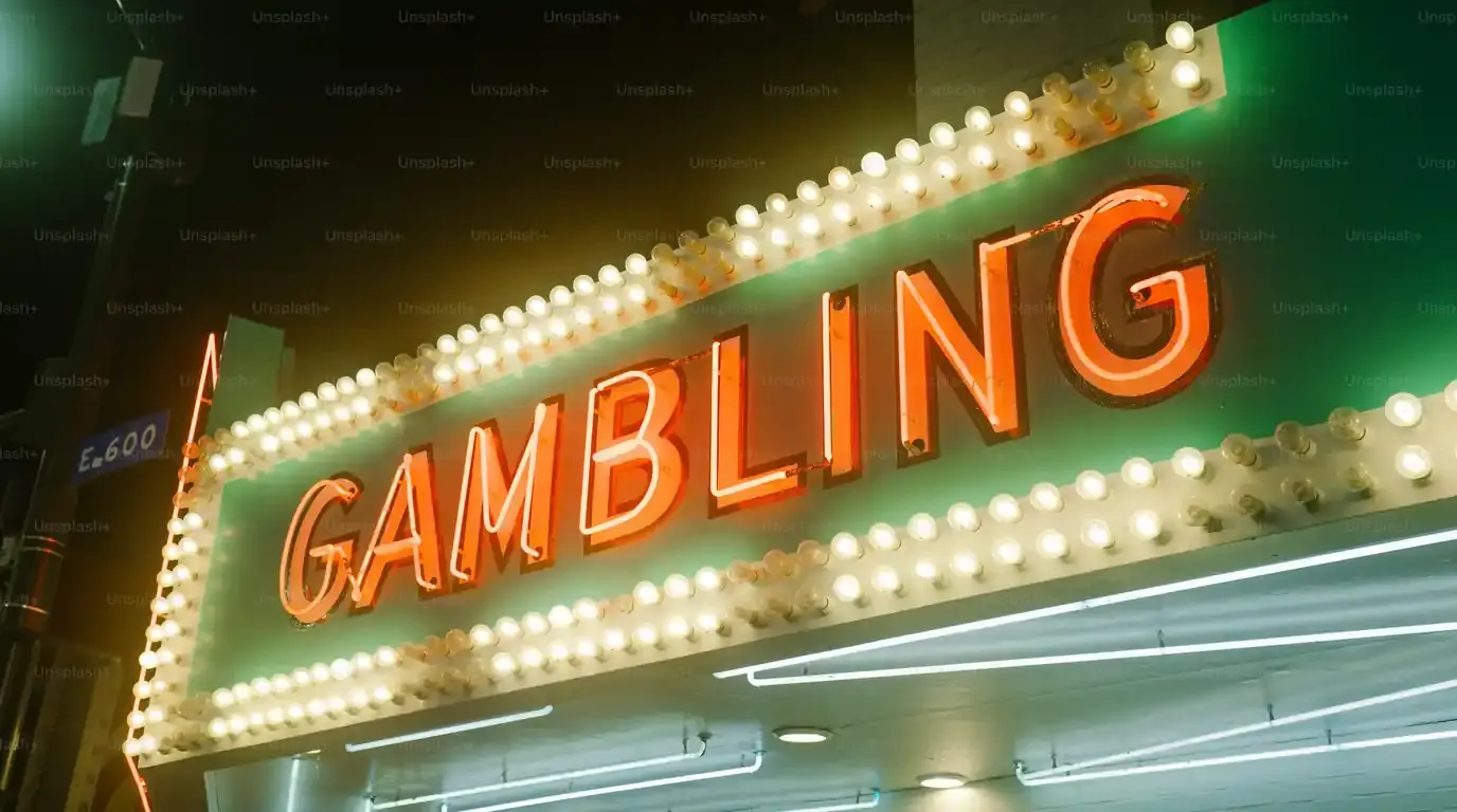 Illuminated theatre-style marquee sign spelling the word gambling