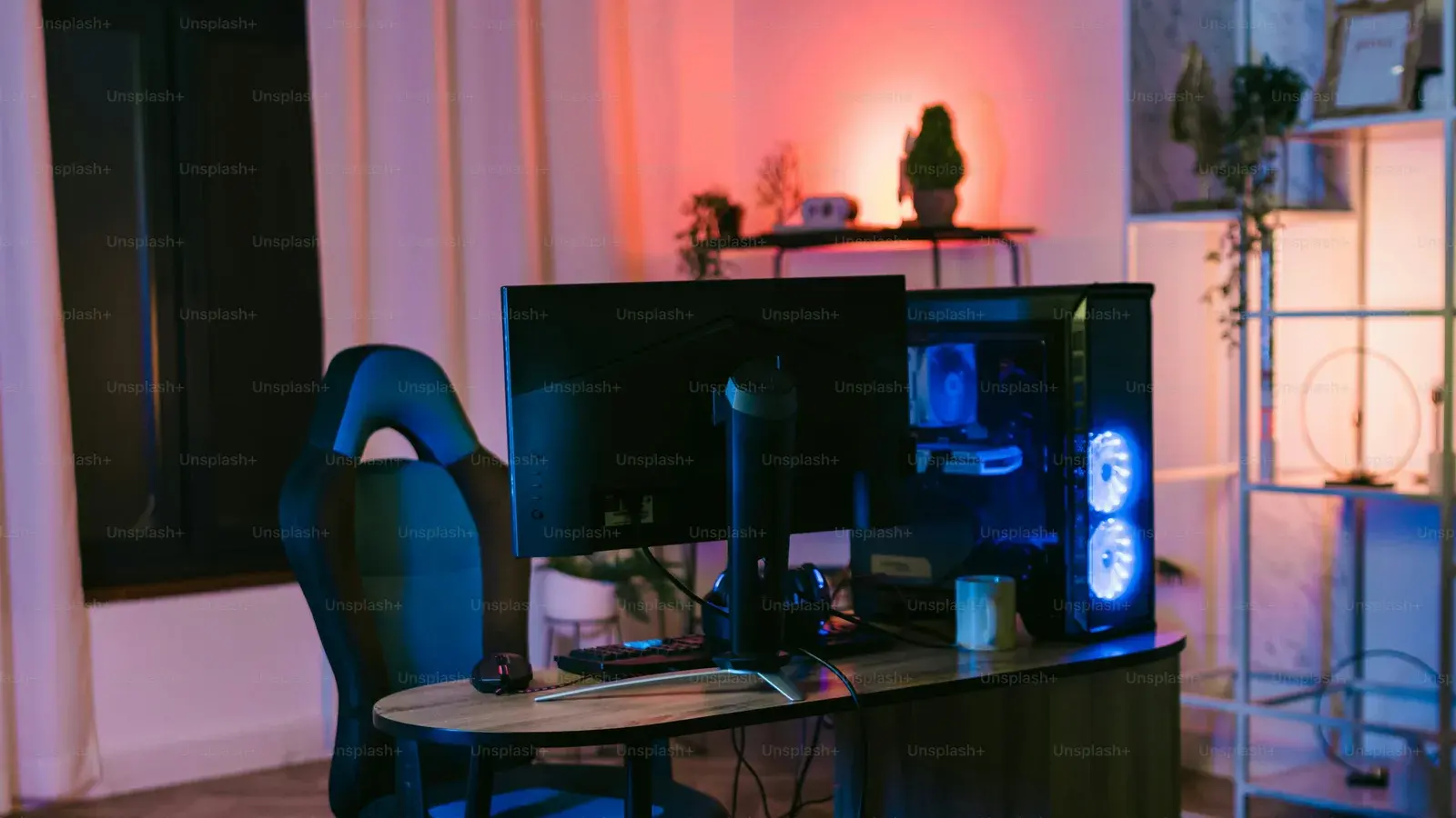 Warm-lit room with a monitor, plants and shelves