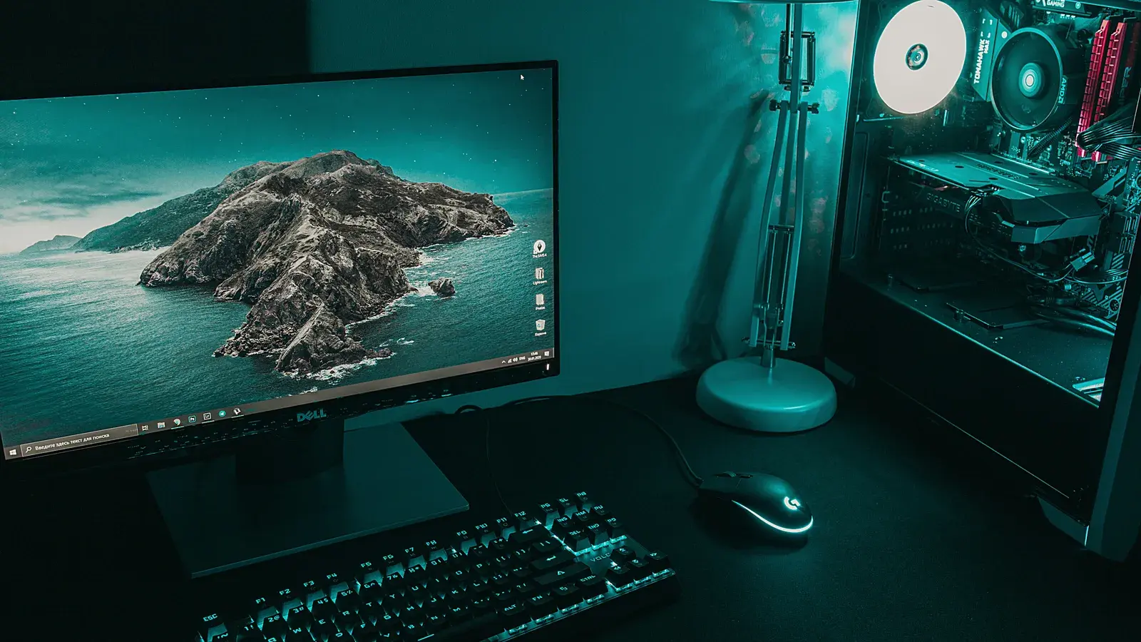 Monitor showing an island map above a keyboard and speaker