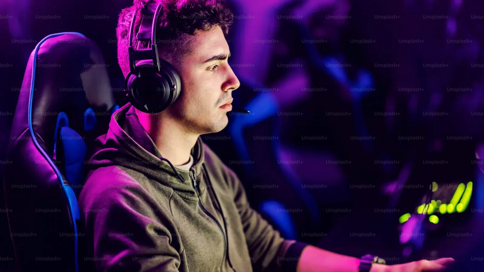 Young man in a headset lit purple and pink