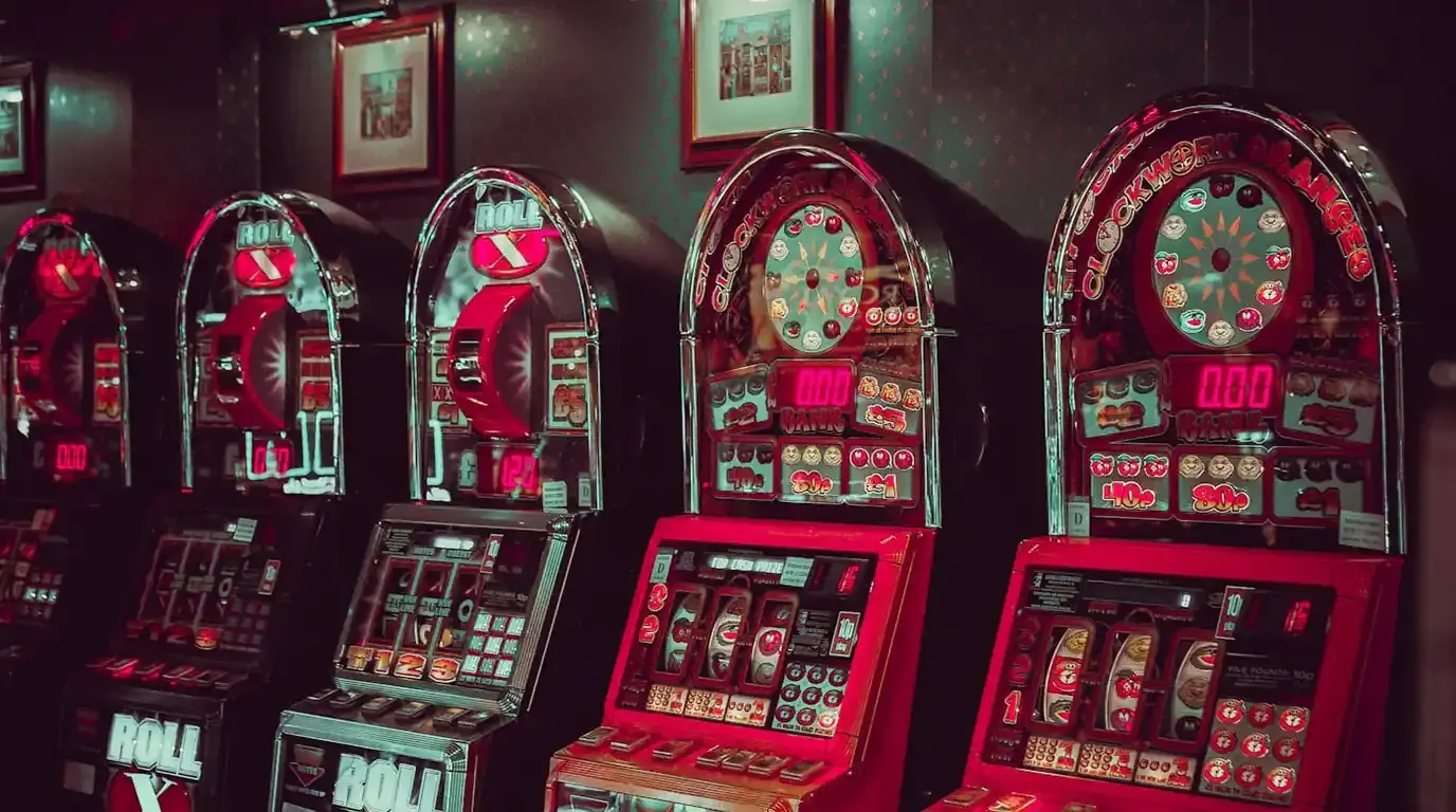 Line of vintage red slot machines with domed illuminated tops