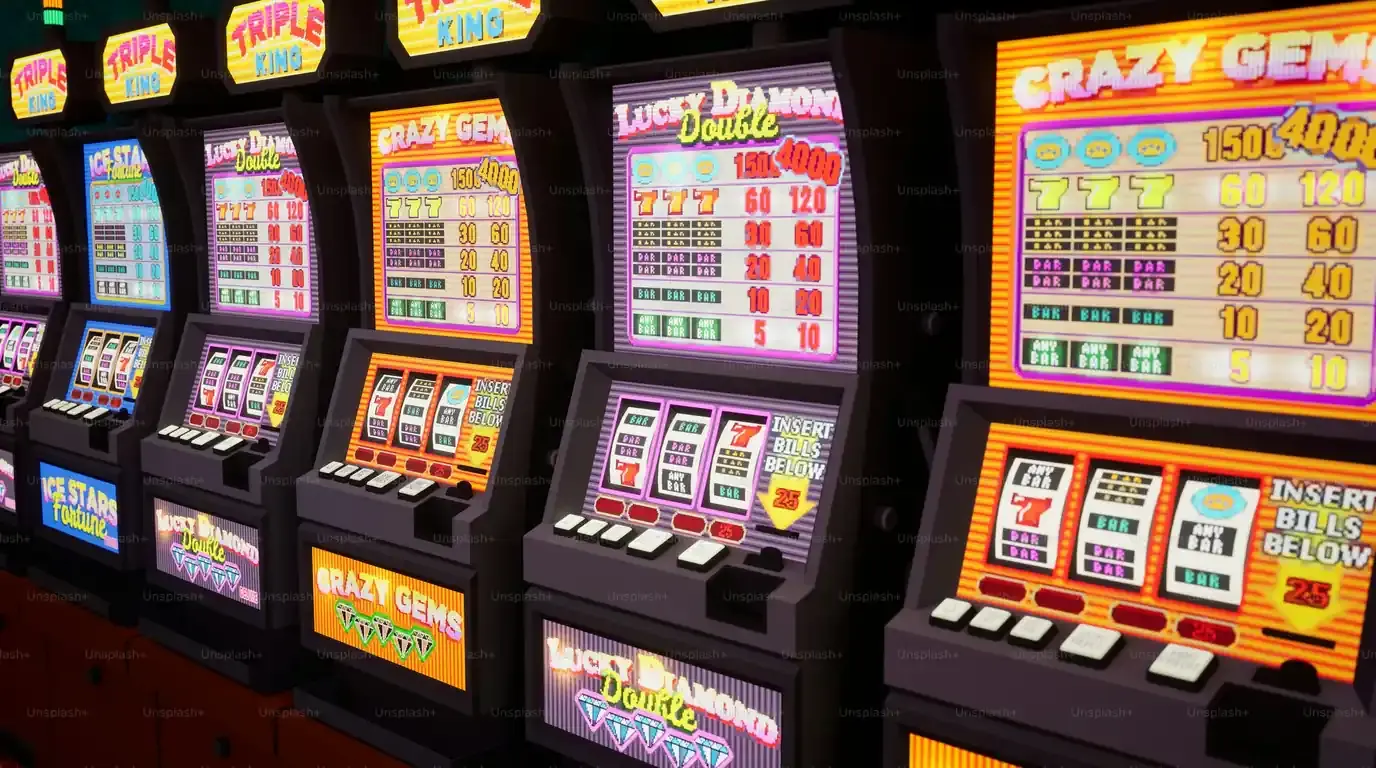 Angled row of bright orange slot machines with lit paytables