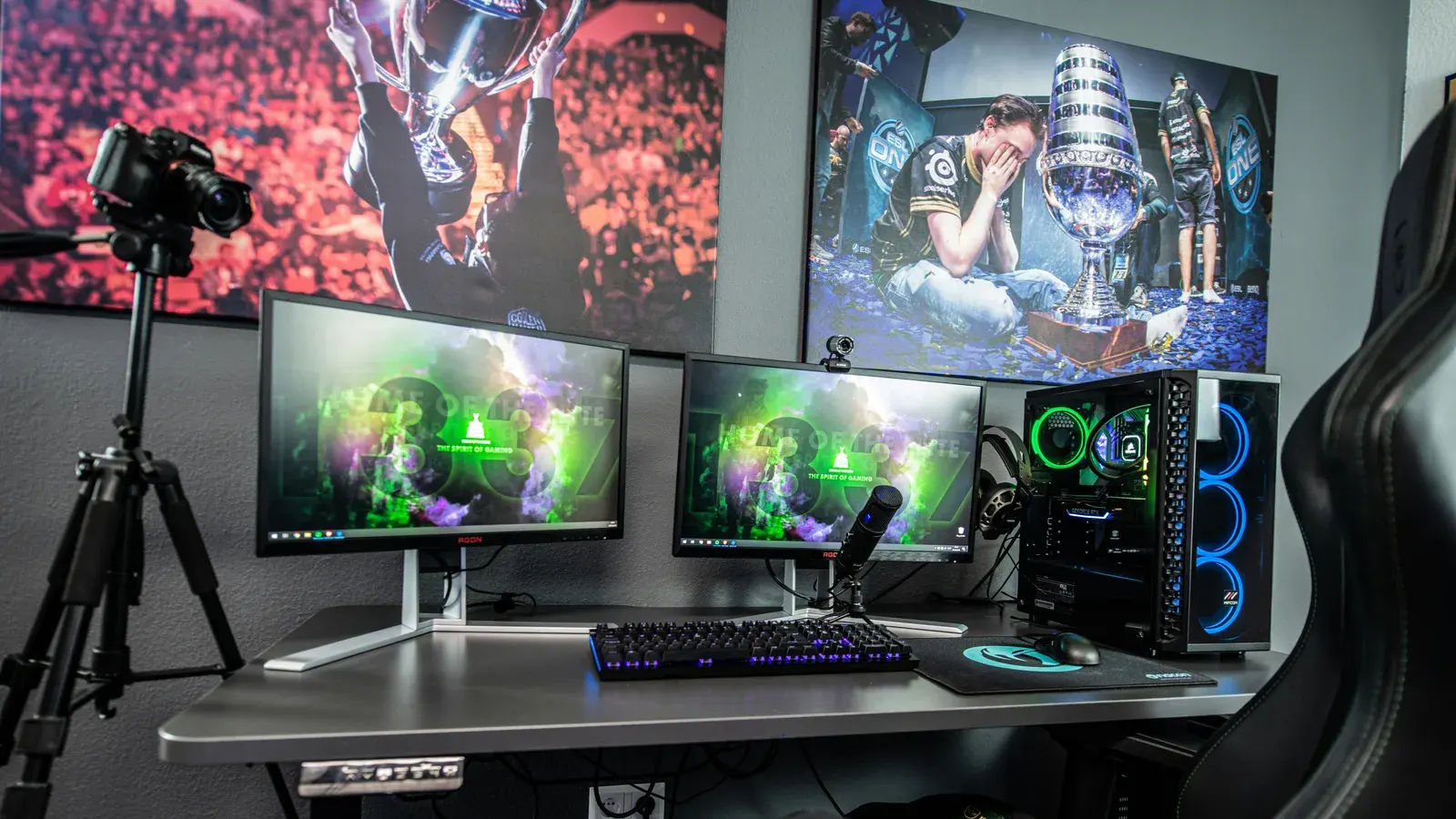 Multi-monitor setup showing games beside a lit PC
