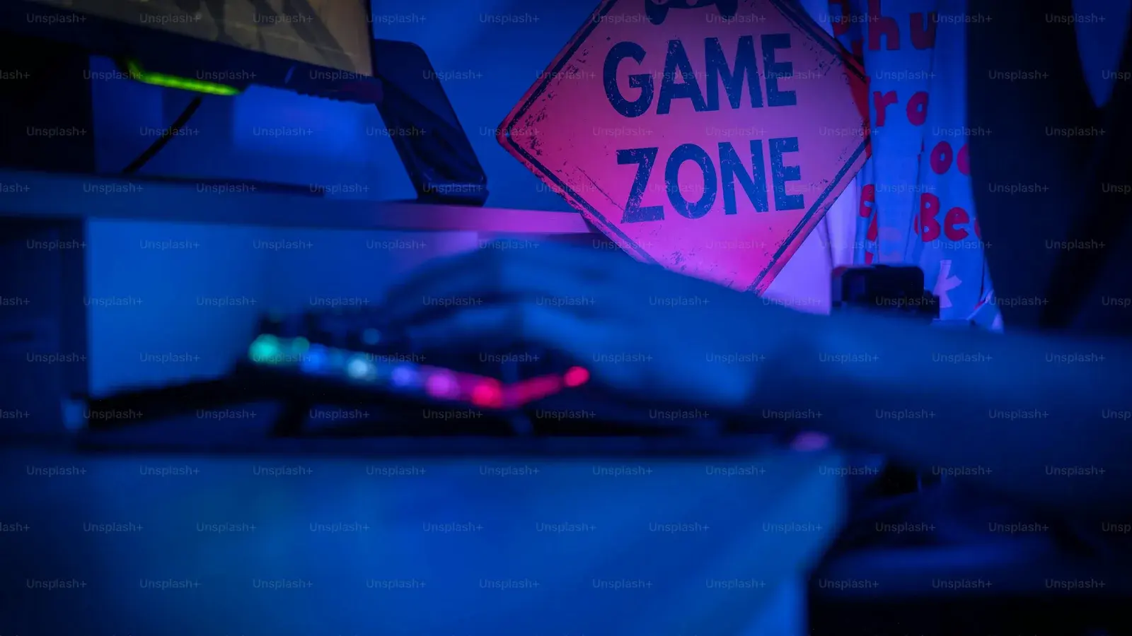 GAME ZONE sign above a keyboard in blue light