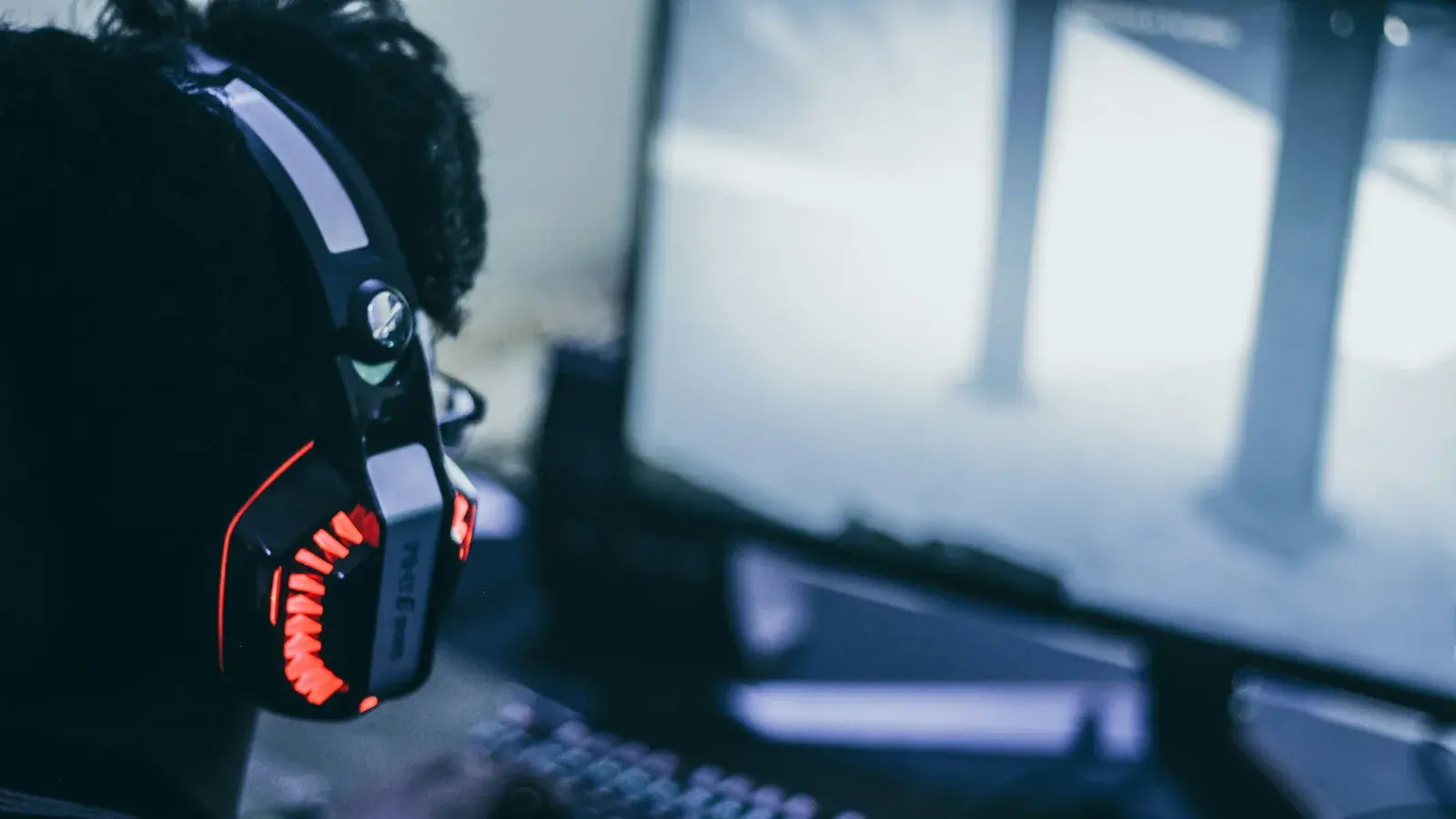 Headset with a red grille in front of a bright screen